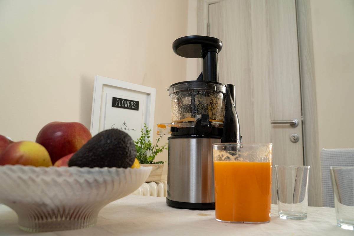 Cold press juicer making fresh raw organic juice at Juicy Jump Bar in Duncanville