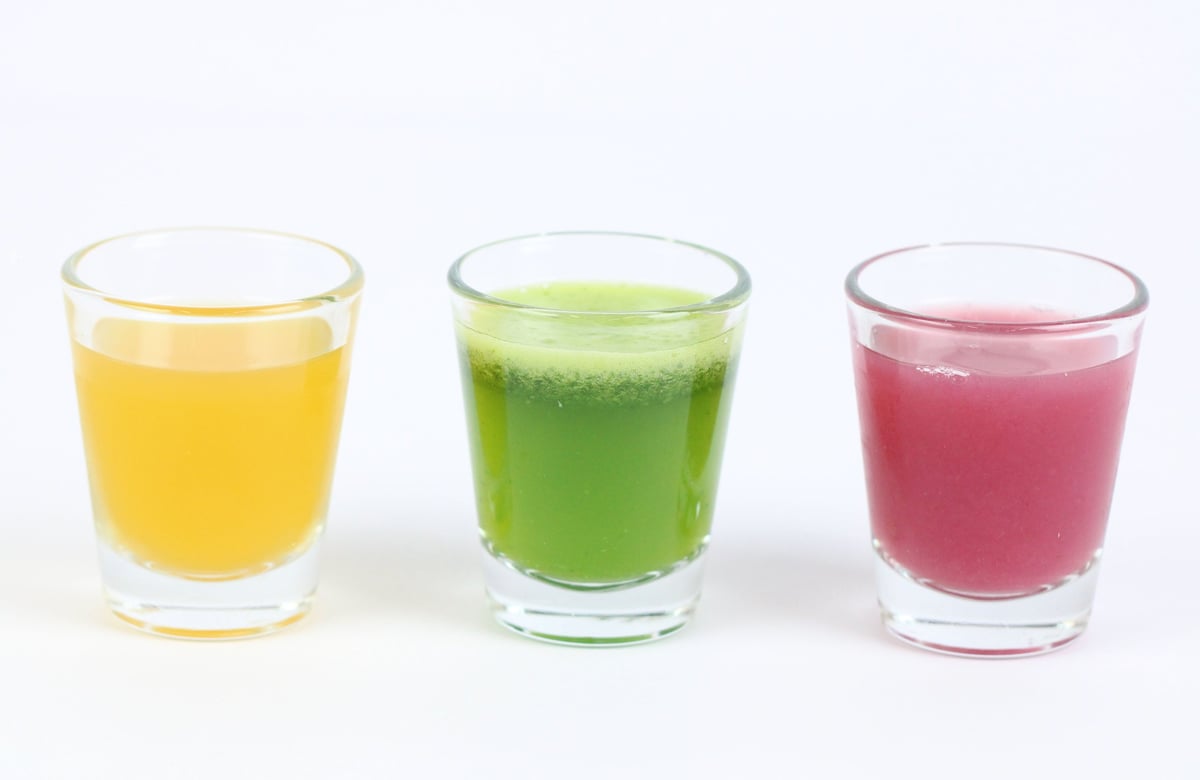 Three vibrant wellness shots from Juicy Jump Bar — yellow, green, and pink immunity-boosting shots